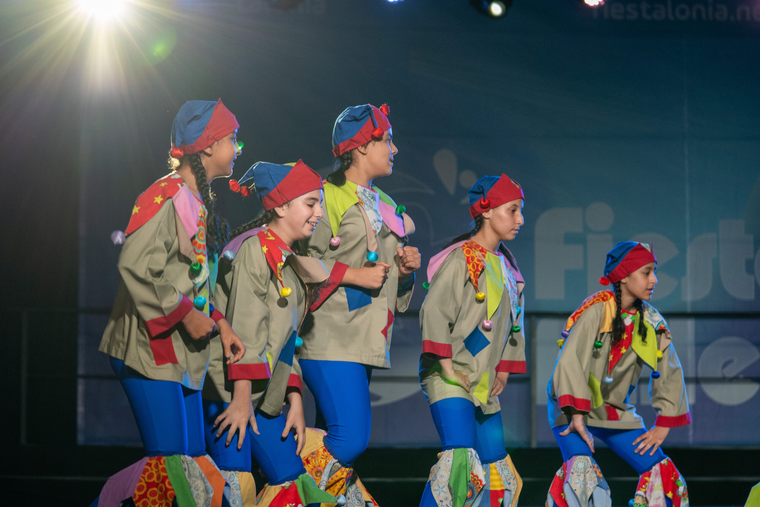 Dancers in colourful costumes on stage, GVM, DF and SS shared archive, April 2025.