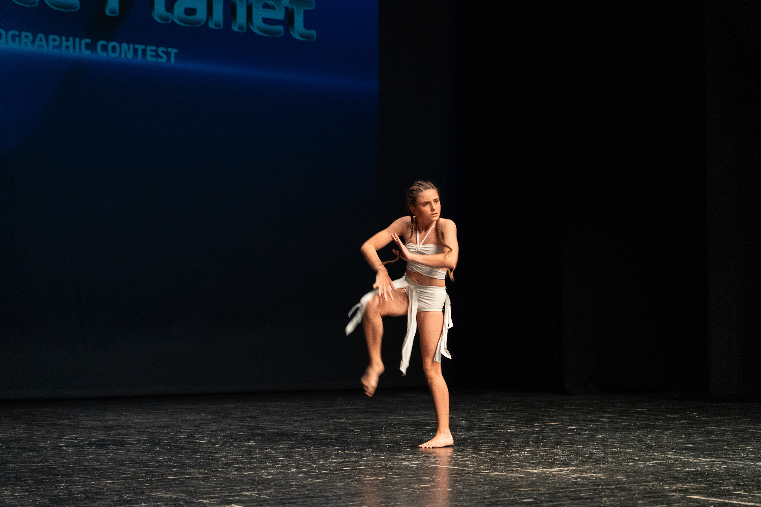 A solo dancer performing on the Global Dance Planet stage, archive May 2026.