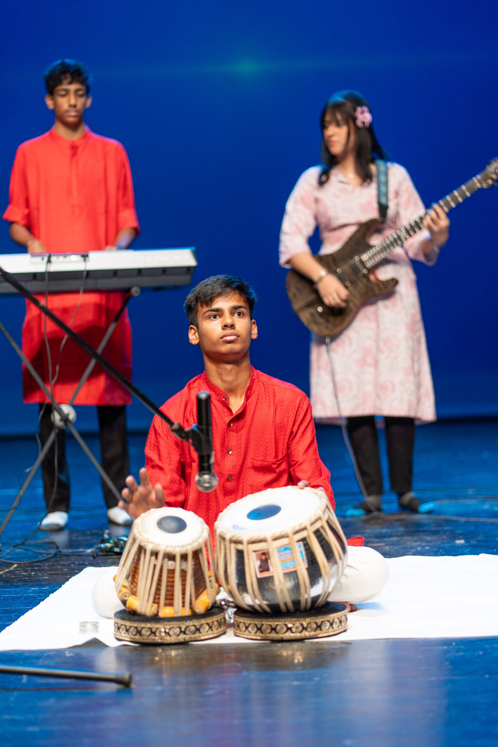 An instrumental ensemble with tabla, keyboard and guitar at Música del Mar, archive June 2025.