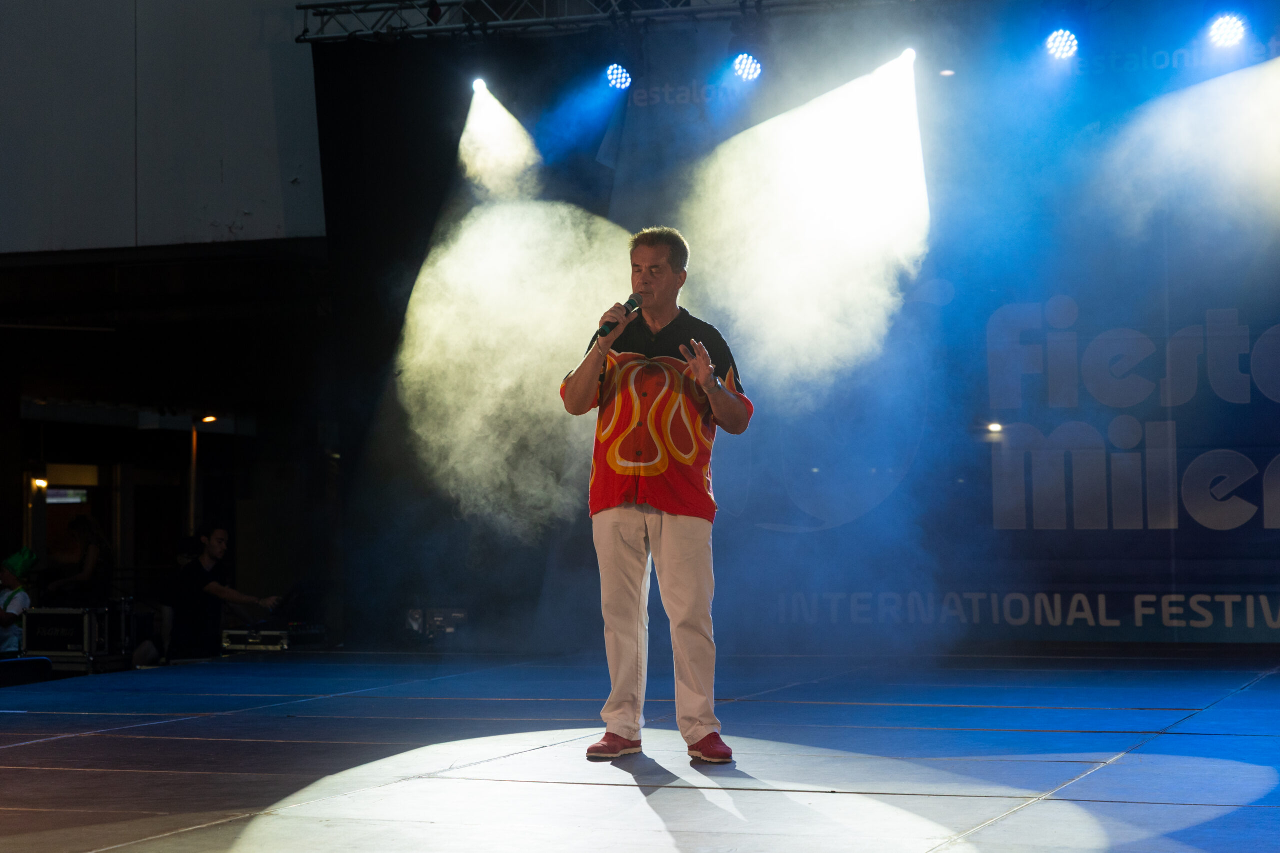 A solo vocalist performing on the outdoor stage at Voices of Costa Brava, archive July 2026.